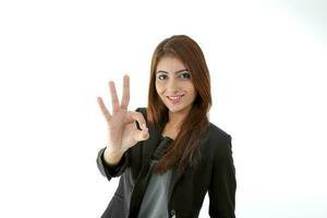 Asian young Indian woman wearing formal business office ware on white background ok hand finger sign photo