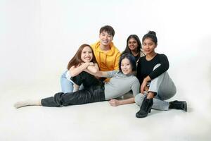 Group of young south east asian mixed race man woman chinese malay indian sit lying pose on floor enjoy relax fun talk gather pose students colleagues look at camera photo