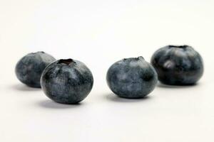 Fresh ripe deep purple Blueberry on white background macro closeup photo