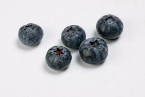 Fresh ripe deep purple Blueberry on white background macro closeup photo