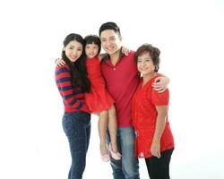 Southeast Asian multigeneration family parents daughter grandmother father mother child pose happy sit stand photo