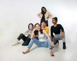 Group of young south east asian mixed race man woman chinese malay indian sit lying pose on floor enjoy relax fun talk gather pose students colleagues look at camera photo