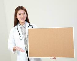 Young Asian female doctor wearing apron uniform tunic apron hold photo