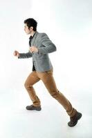 Middle eastern Caucasian young office business man wearing suit pose run sprint on white studio background photo