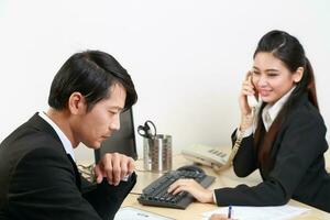 Young Asian man woman wearing business office suit chair table computer white background photo