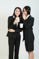 Two young asian malaysian business office woman holding blank copy text space sign board on white background photo