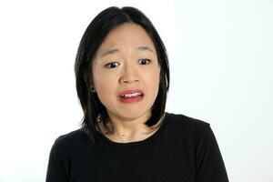 Young attractive south east asian woman pose face expression emotion on white background think worry sad upset photo