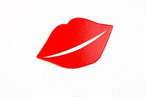 Red female lip shape paper die cut selfie portrait party fun paper prop sticker stick on white background photo