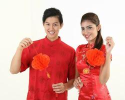 South East Asian young Malay Chinese Indian man woman wearing traditional chinse cheongsam dress on white background shop exchange gift orange greetings share racial unity harmony hand fan photo