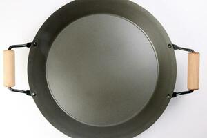 Cast metal not stick two wooden handle empty flat bottom frying pan on white background photo