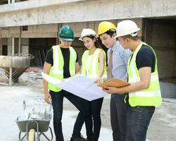 South East Asian young Malay Chinese man woman wearing safely helmet construction site work photo