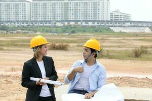 South east Asian construction worker engineer management at construction site hard safety hat helmet photo