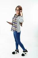 Yong south east Asian youth girl in casual dress eye wear tab pad posing walk look at camera on white background photo