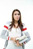 Yong Asian youth girl in casual dress carrying heavy book look at camera funny face expression difficult on white background photo