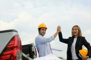 South east Asian construction worker engineer management at construction site hard safety hat helmet photo