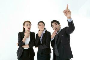 Southeast Asian young office business man woman wearing suit point finger showing up expressions surprise wonder wow on white studio background photo