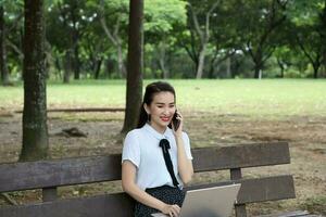 Young asian chinese woman outdoor park campus book photo