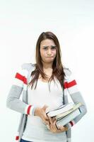 Yong Asian youth girl in casual dress carrying heavy book look at camera funny face expression difficult on white background photo