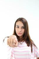 Yong Asian youth girl in casual dress point finger at camera on white background photo