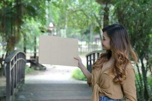 Young Asian Malay man woman outdoor green park walk talk discuss mingle photo