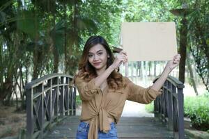 Young Asian Malay man woman outdoor green park walk talk discuss mingle photo