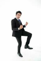 Southeast Asian young office business man wearing suit fist dance successful happy expression look at camera on white studio background photo