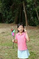 South East Asian young father mother daughter son parent boy girl child activity outdoors park photo