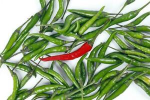 Fresh birds eye green chilli scattered isolated unique red chilli top view on white background photo