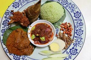 Coconut steam nasi lemak beef rendang chicken berampa fried set half boil egg petai sambal sauce peanut anchovy photo