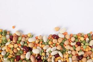 Mixed beans multi grain colorful mixture horizontal line frame border copy text space on white background photo