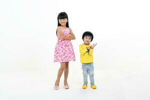 South East Asian young girl boy child brother sister siblings playing happy posing on white background photo