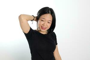 Young attractive south east asian woman pose face expression emotion on white background hand in hair photo