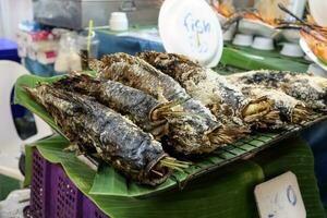 Salt bake fish at street stall photo