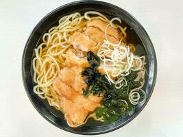 Chicken chop seaweed ramen noodle soup in bowl photo