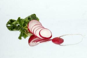 Small red radish on white reflection ackground photo