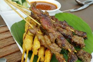 Satay chicken beef with peanut sauce onion ketupat rice cake photo