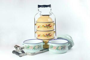 Vintage retro tin tiffin food two three tier carrier on white background photo