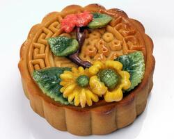 Colorful flower decorated mooncake Chinese mid autumn festival on white background photo