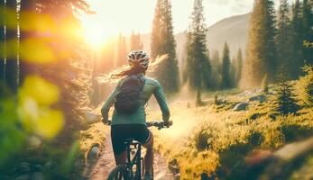 Mountain biking woman riding on bike in summer mountains forest landscape, photo
