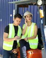 South East Asian young Malay Chinese man woman wearing safely helmet construction site work photo