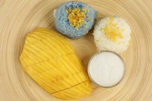 Mango butterfly pea blue white sticky rice coconut milk cream photo