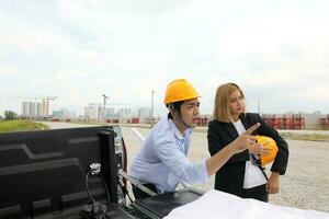 South east Asian construction worker engineer management at construction site hard safety hat helmet photo