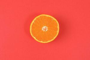 Mandarin Orange Fruit slice half juiced extracted on red background photo