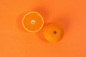 Mandarin Orange Fruit slice half on orange background photo