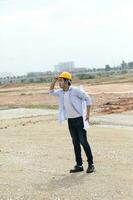 South east Asian construction worker engineer management at construction site hard safety hat helmet photo