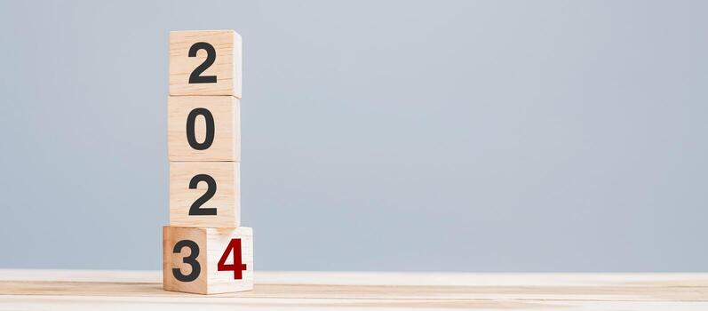 2023 chang to 2024 wooden cube blocks on table background. Resolution, plan, review, goal, start, end year  and New Year holiday concepts photo