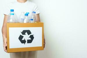 Volunteer keep plastic bottle into paper box at home or office. Hand Sorting Recycle garbage. Ecology, Environmental, pollution, Dispose recycling, waste management and trash Separation concept photo