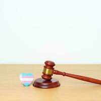 Transgender Day, LGBTQ Law and Pride month concepts. gavel justice hammer with blue, pink and white heart shape for Lesbian, Gay, Bisexual, Queer, Intersex photo