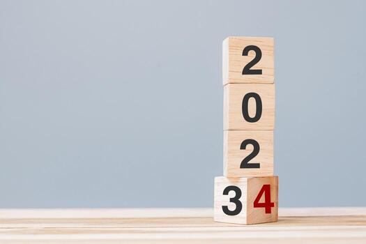 2023 chang to 2024 wooden cube blocks on table background. Resolution, plan, review, goal, start, end year  and New Year holiday concepts photo