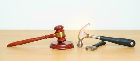 Labor law and Worker concepts. Construction hammer with gavel justice hammer on desk in courthouse. photo